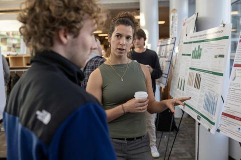 Chemistry student presenting at a poster presentation