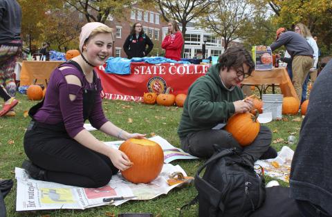 Students carving pumpkins